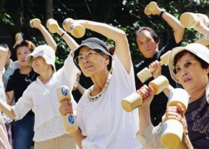 Elderly people use pairs of wooden dumbbells exercise during a health promotion event at a Tokyo temple on Respect the Aged Day, Monday, Sept. 17, 2007. Nearly 22 percent of Japan's population is aged 65 or older, a new high in one of the world's most rapidly aging societies, according to a government data. - AP