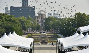 Doves fly over the Hiroshima Peace Memorial Park in western Japan on August 6, 2015 during a memorial ceremony to mark the 70th anniversary of the atomic bombing of Hiroshima. Tens of thousands gathered for peace ceremonies in Hiroshima August 6 on the 70th anniversary of the atomic bombing that helped end World War II, but still divides opinion today over whether the total destruction it caused was justified. AFP PHOTO / KAZUHIRO NOGI